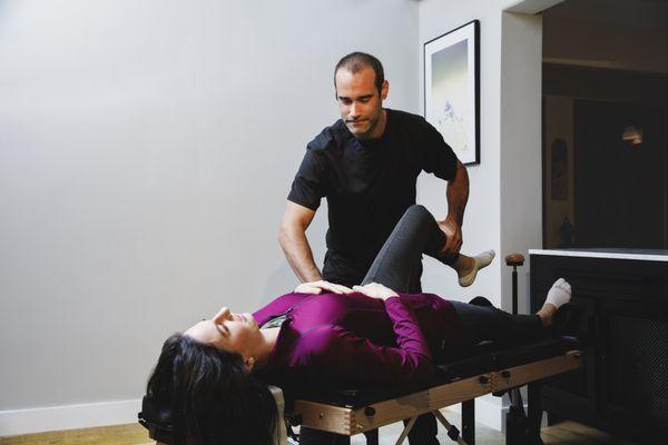 Manual therapy being performed on a patient for a home visit.