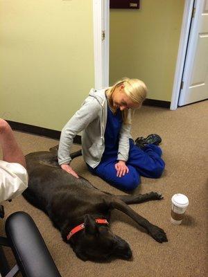 one of our massage therapists with Dr. Matts dog, we are all dog lovers