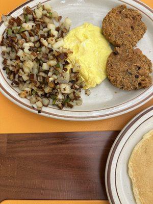 2 Eggs with 2 Salmon Croquettes and home fries w/ green peppers and onions.