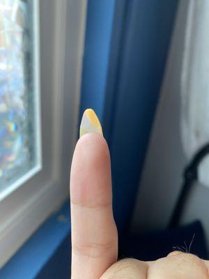 Natural nail left long under the tip