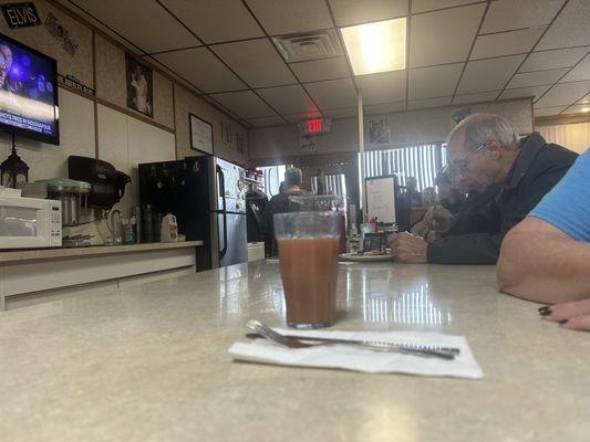 Inside sitting at counter.