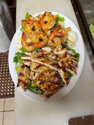 Grilled chicken caesar salad with grilled shrimp and egg added.