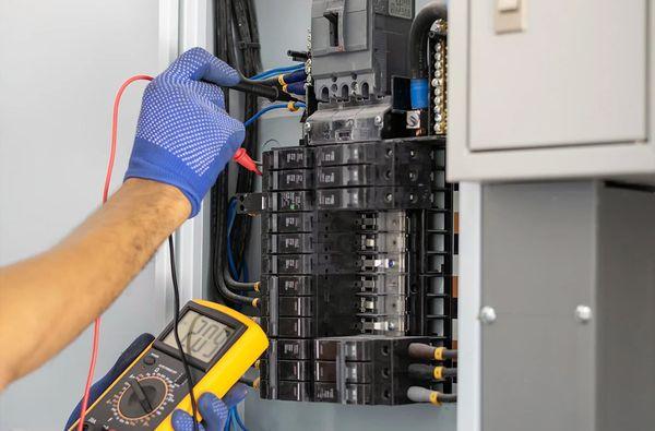 Electrician checking the setup of a circuit breaker panel