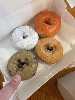 Blueberry cake donut ! Powdered sugar cake , cinnamon sugar cake , strawberry frosted donut .