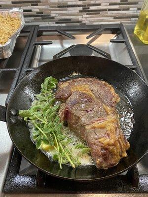 Searing the rib eye with some oregano