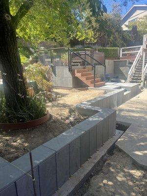 planter wall with stone tile finish to patio retention walls