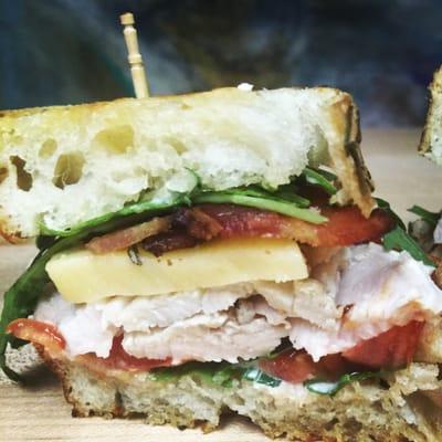 AB turkey Breast makes a great Sammy!  Here on fresh baked Rosemary bread organic arugula heirloom tomatoes local bacon & GOUGA