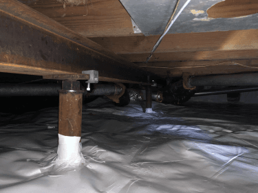 Crawl space with supports installed to fix sinking or sagging floors.