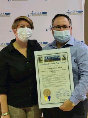 Alain Azcona,CEO accepting Healthcare Heroes Proclamation from San Diego City Council Member 
Marni Von Wilpert 5/11/2022