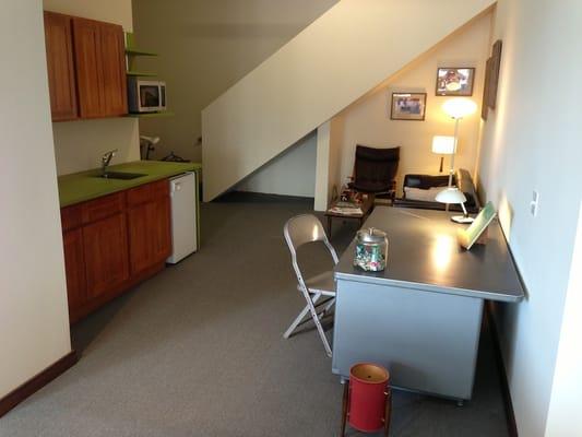 Our kitchen with fridge and microwave and out staircase to the upstairs classroom