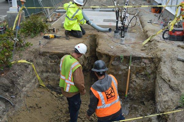 Digging a trench for the new 12Kv primary conduit, when complete we will pour slurry concrete over all the conduits.