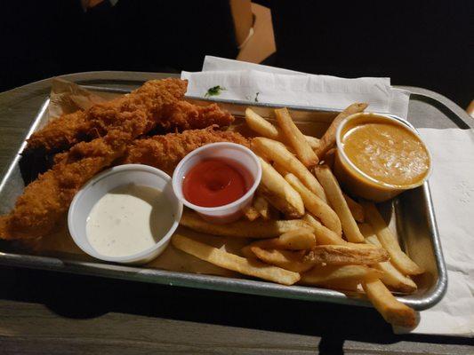 Coconut Chicken Tenders with fries and a side of queso.