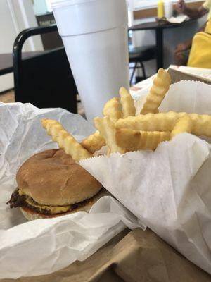 Cheese burger with a side of fries and fountain drink