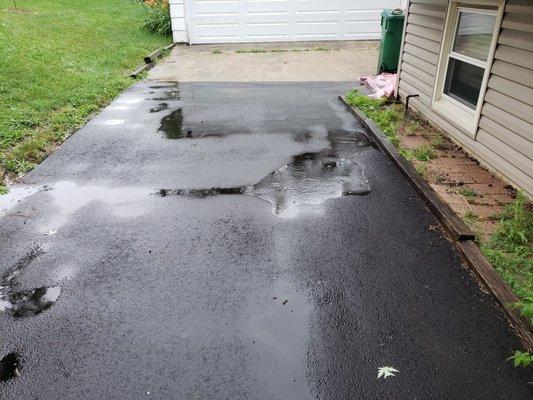 The water pools and flows backwards towards the rear of the house