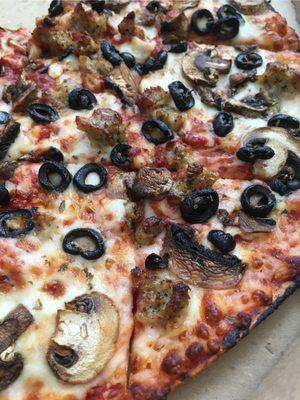 Sausage, olives and mushrooms on thin crust