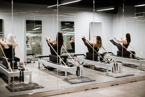 Group reformer class at The Pilates Loft Columbia Pike.