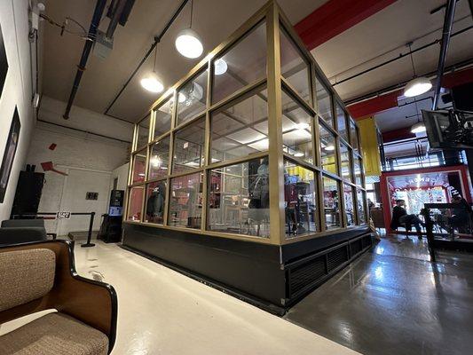 The glass cube inside boxes out some of the sound of the coffee roasters are in operation