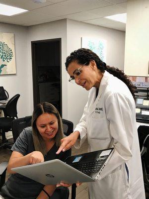 Dr. Gabal reviewing records with her staff.