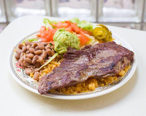 Steak Rice Plate comes with rice, beans, lettuce, and pico de gallo. Guacamole is extra charge.