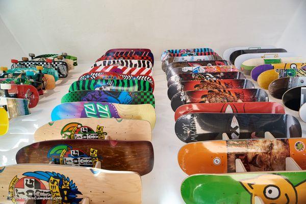 Rows of old school decks and popsicle skateboard decks.