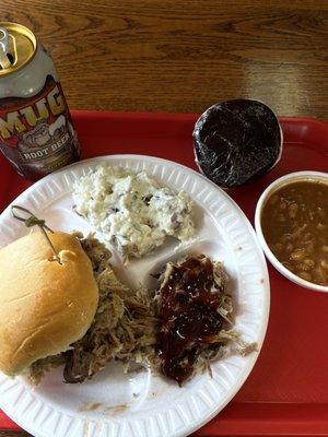 Pulled pork sandwich with potato salad, baked beans, and homemade whoopie pie