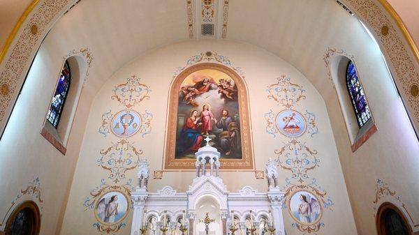 A view of the sanctuary at Holy Family, highlighting the portrait.