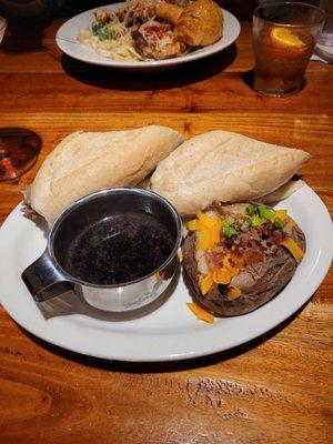 Prime rib sandwich with loaded baked potato