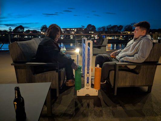 Son and wife enjoying a game of Connect Four on the top deck