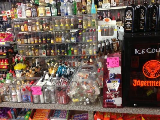 Many different kinds of miniature shot bottles of Liquor including some 99 cent brands.