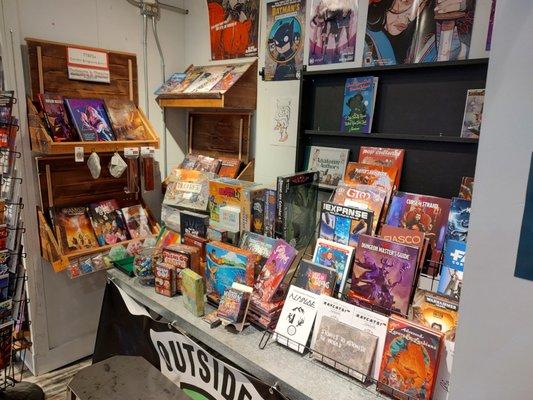 Outsider Comics gaming (TTRPG) and board games section.