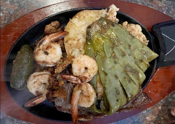 Parrillada- shrimp, chicken, steak, chorizo, nopal served with tortillas and a side of black beans and rice