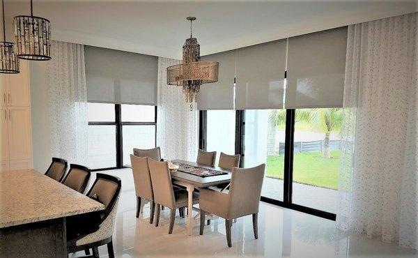 1% openness motorized roller shades with embroidered sheer accent panels.