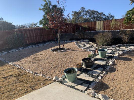 Full backyard remodel we did featuring crushed granite, Colorado River rock, Black dyed mulch and Mexican swirl flagstone!