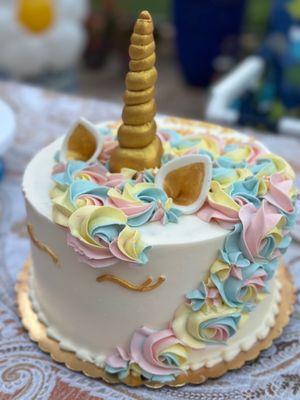 Unicorn cake with pastel colors and gold lettering