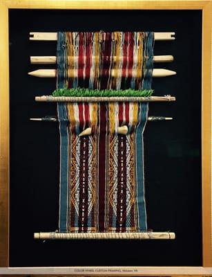 Custom framed at Color Wheel, this Peruvian piece is a woven tapestry still on the loom with hand carved wooden dowels and bone.