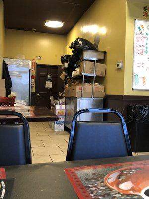 overflowing garbage and cardboard boxes in the dining room