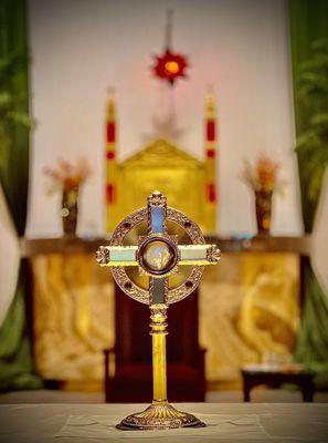 Portrait mode of Jesus in the Eucharist in the Monstrance on the Altar during Eucharist Adoration