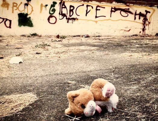 A sad reminder that the homeless include children. Looks like one used this wall as a classroom.