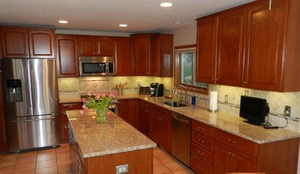 Full kitchen remodel in Novi. Cabinets by Michigan Kitchen Cabinets, granite, tile splash and LED under cabinet lighting.