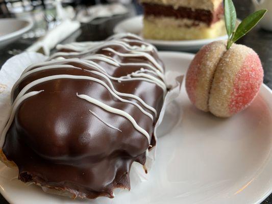 Close up of an eclair and peach cookie