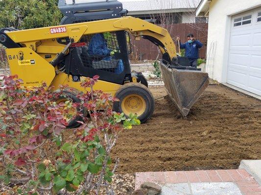 Grading, removing excess dirt.