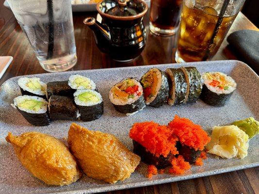 Avocado maki (top left), veggie fever roll (top right), inari (bottom left), and masago (bottom right).