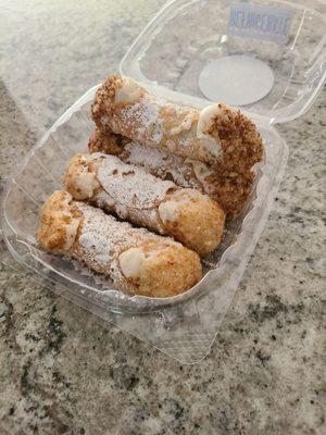 Fresh traditional cannoli and apples and cinnamon cannoli.