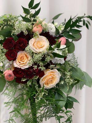 Bridal bouquet with lush greenery, garden roses, ranunculus, spray roses, Queen Anne's lace and carnations