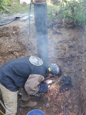 One of our technicians, replacing a well casing and conduit.