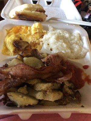 Scrambled egg w/cheese, load of delicious thick bacon, "real" home style potatoes, biscuit, & delicious, fully cooked, thick grits!