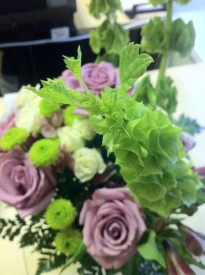 Lovely Lavender Bouquet - lavender roses, alstroemeria, white spray roses, bells of Ireland, green frosted vase. Photo by Vyvy.