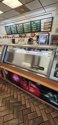 The employee covered the glass so that what he was going to order could not be seen.  First time he went through this at a Subway.