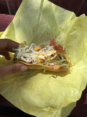 Taco dorado filled with chicken, lettuce, tomato, onion, cheese