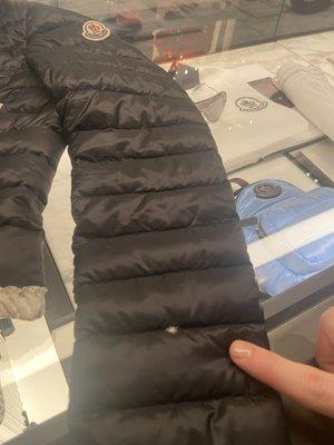 Feather coming through seam.  At Moncler store to drop off for repair.